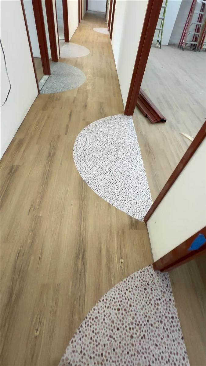 LVP corridor with terrazzo-style inlays
