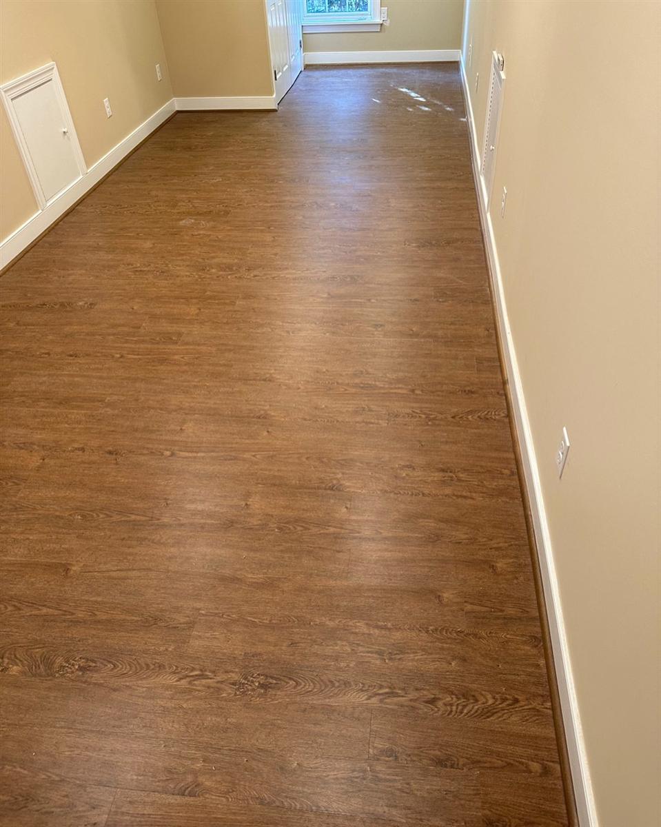 Engineered hardwood glue-down in a long room